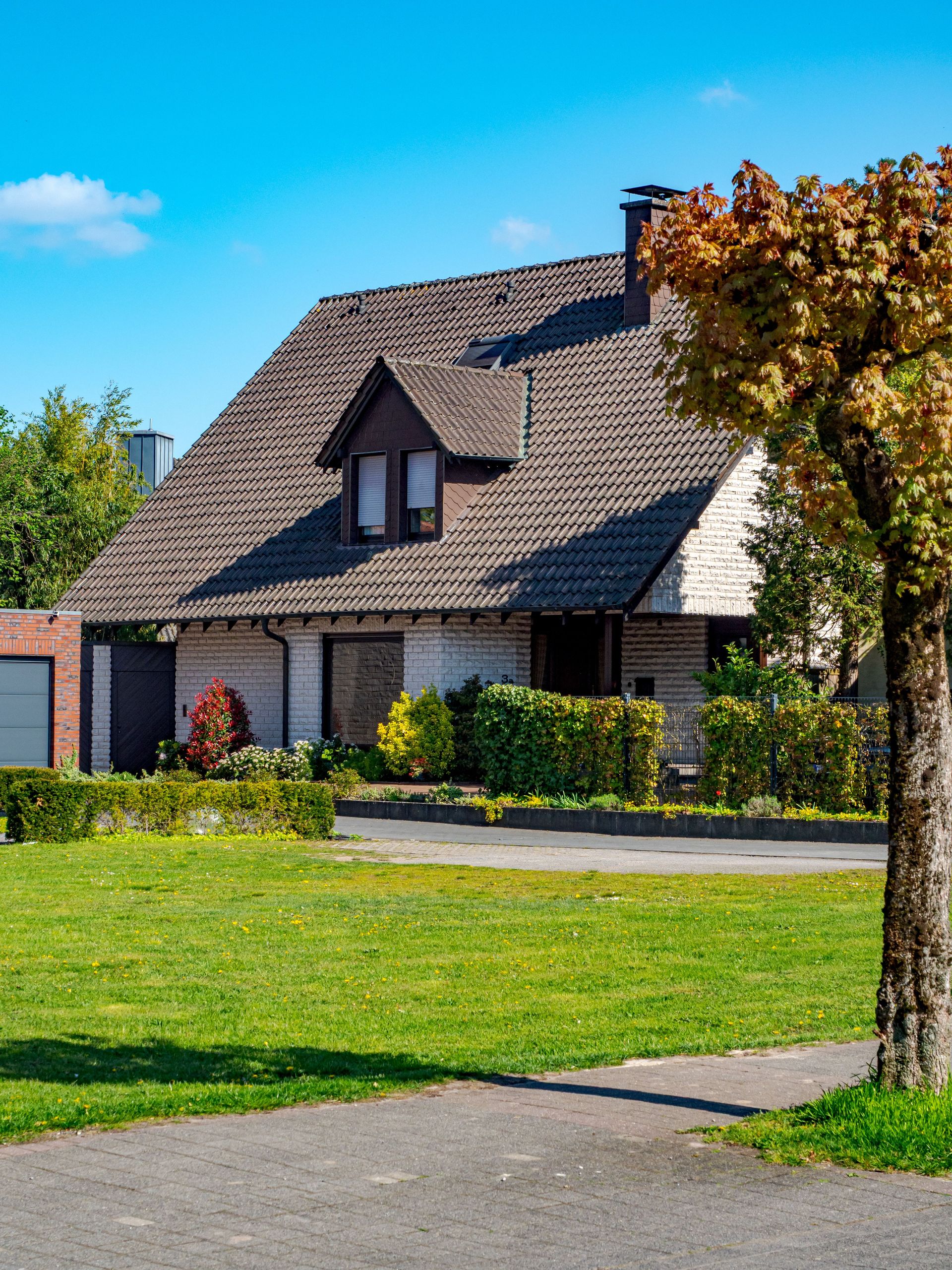 Cozy suburban house with a garden in Coesfeld, Germany on a sunny day.